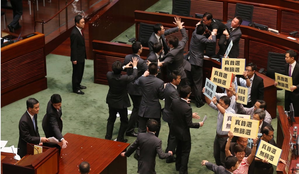 The incident took place at a question-and-answer session at the Legislative Council in July 2014, during which Wong hurled a number of objects, including a glass that shattered behind then chief executive Leung. Photo: K.Y. Cheng