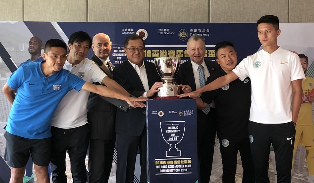 Players and officials from Wofoo Tai Po and Kitchee pose with the Community Cup.