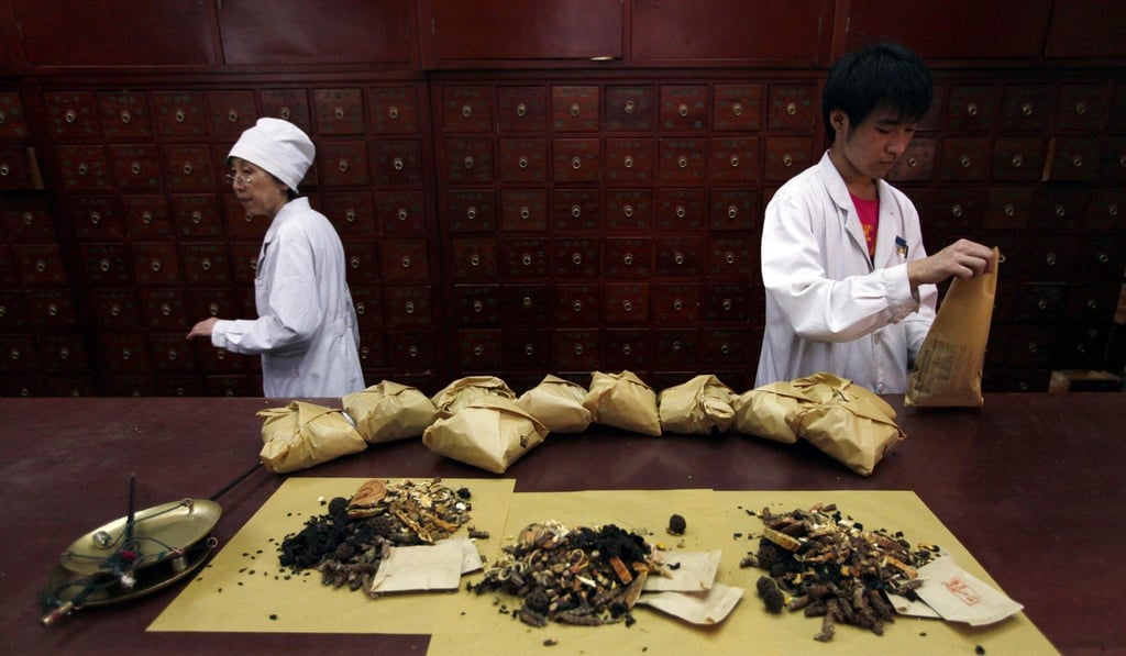 Workers prepare remedies at Capital Medical University’s TCM hospital in Beijing. Photo: Reuters Workers prepare remedies at Capital Medical University’s TCM hospital in Beijing. Photo: Reuters