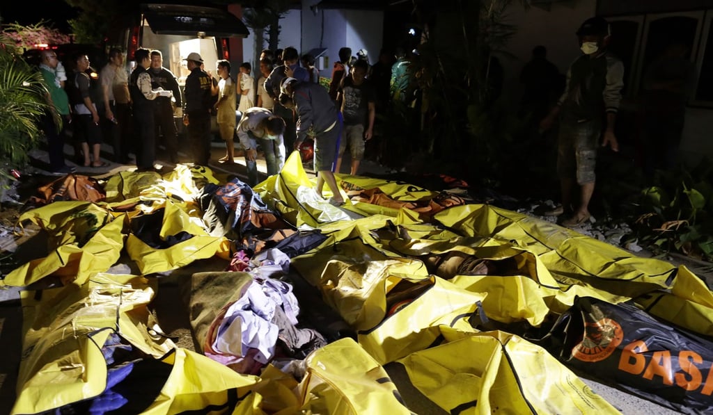 Bodies were lined up along the streets, some in bags and some with their faces covered with clothes. Photo: Reuters Bodies were lined up along the streets, some in bags and some with their faces covered with clothes. Photo: Reuters