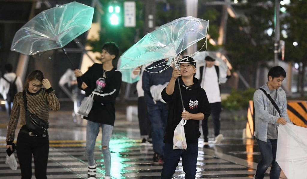 Commuters in Nagoya, central Japan, fight strong winds and torrential rain as yet another typhoon batters Japan. Photo: AP