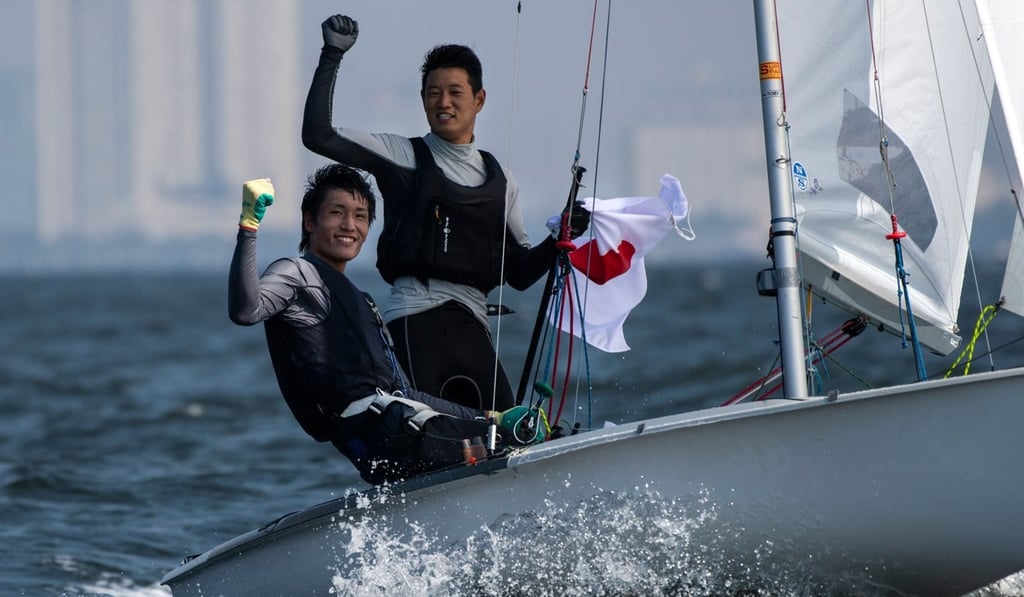 Japan's Tetsuya Isozaki (R) and Akira Takayanagi gesture to photographers at the end of the 470 men sailing competition at the 2018 Asian Games. Photo: AFP