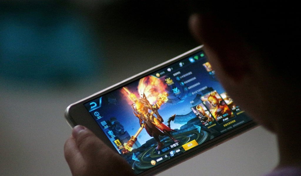 A child plays the game “Honour of Kings” by Tencent at home in Dezhou, Shandong province, China July 2, 2017.