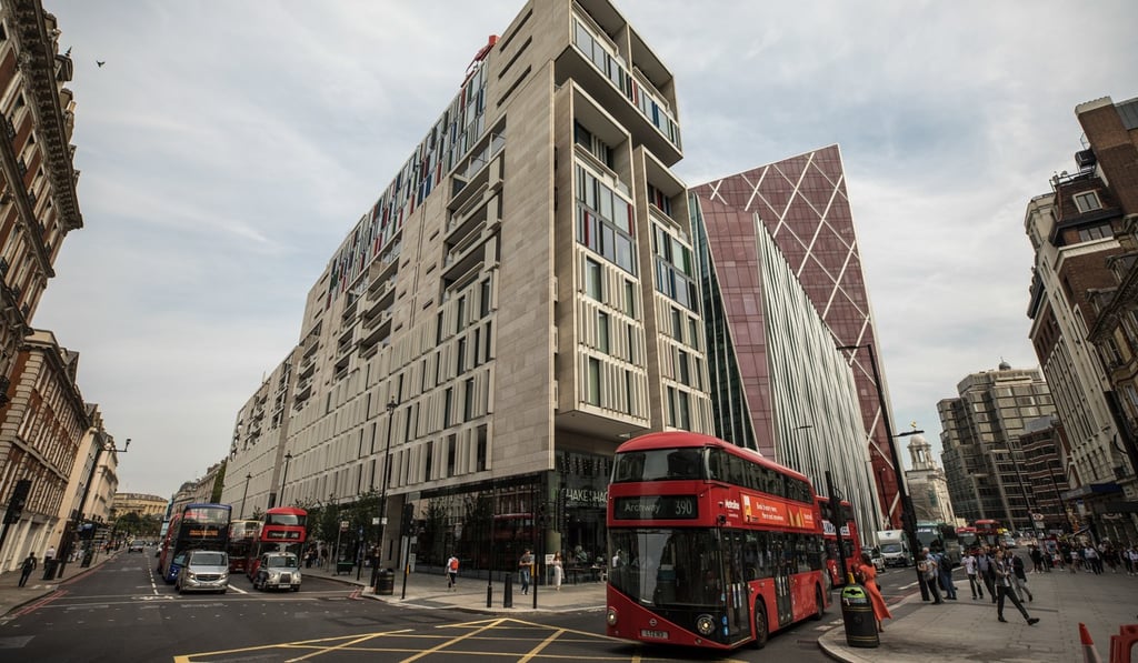 A red London buses passes The Nova Building, a mixed residential and commercial use building in the Nova development in the Westminster borough of London. Photo: Bloomberg