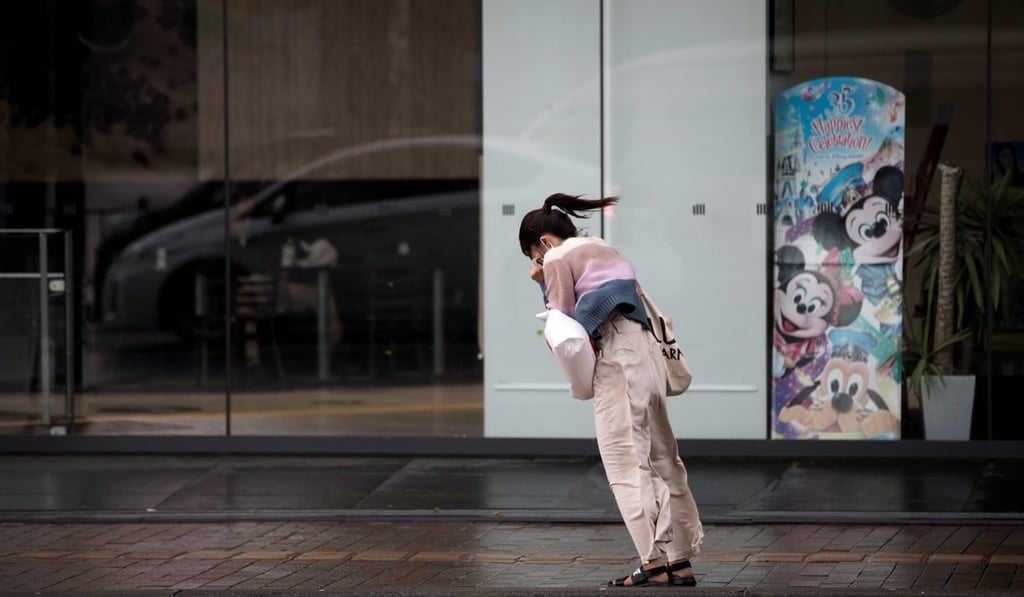 A woman walks against the strong winds after Typhoon Trami hit the city of Kagoshima on Kyushu island on September 30. Two people have been killed in the powerful storm. Photo: AFP A woman walks against the strong winds after Typhoon Trami hit the city of Kagoshima on Kyushu island on September 30. Two people have been killed in the powerful storm. Photo: AFP