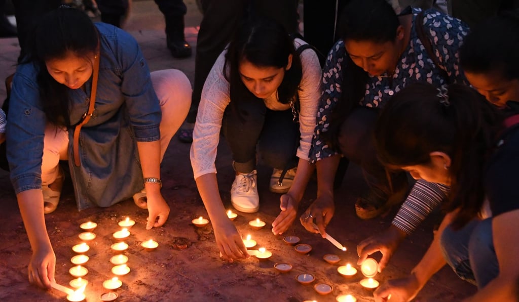 Nepali youth activists light candles in honour of victims of acid attacks in Kathmandu. Photo: AFP