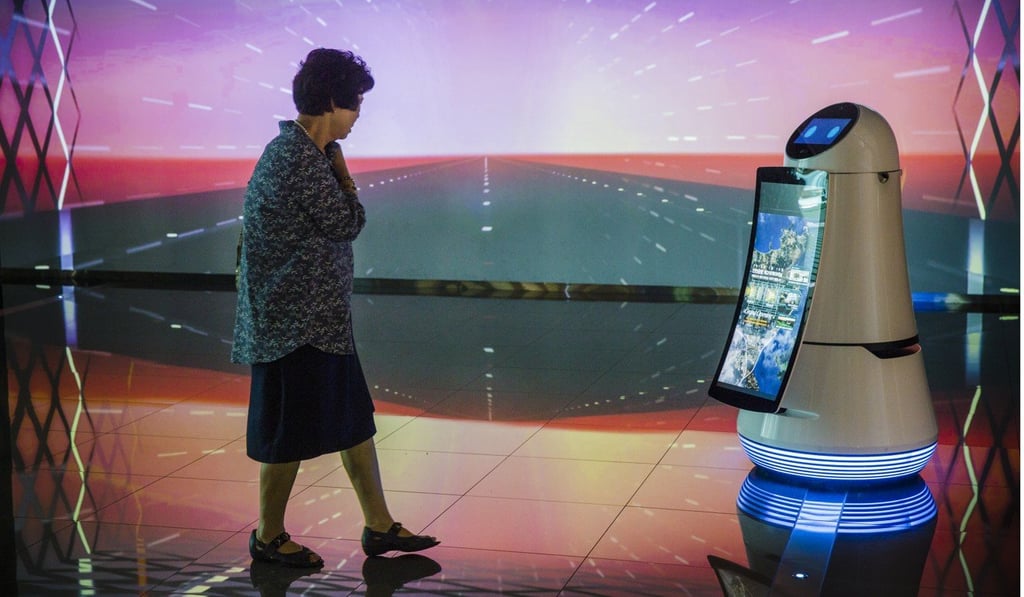 An airport visitor interacts with a robot on display at Incheon International Airport.