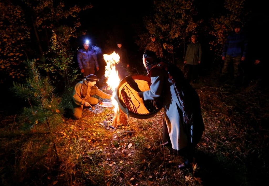 Shaman Svetlana Kochitaeva leads a ritual devoted to the autumn equinox with a group of people outside the village of Muzhichkino, in the Krasnoyarsk region of Russia. Photo: Reuters