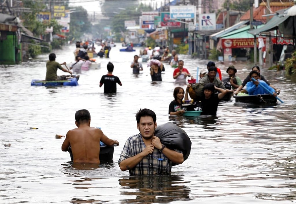 Thai residents flee flooding on the outskirts of Bangkok in October 2011. Picture: EPA