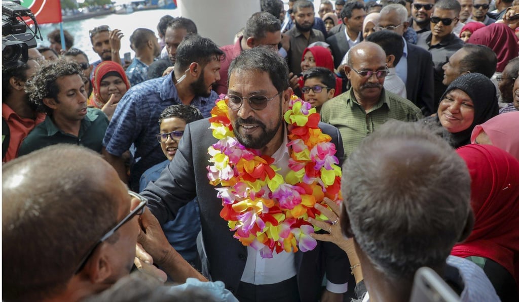 Maldives opposition leader Qasim Ibrahim is welcomed after returning from exile in Germany. Photo: AP