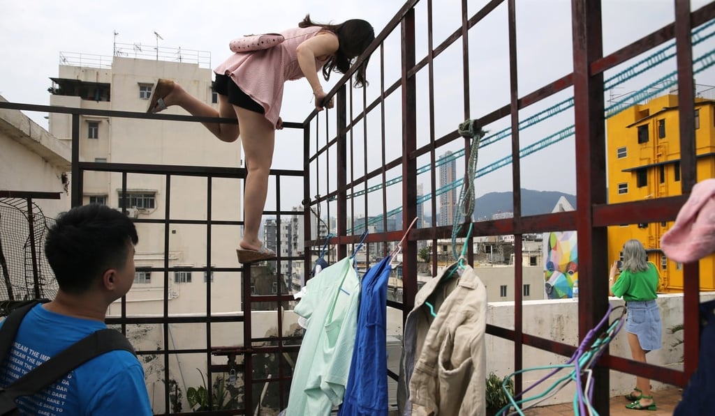 A woman in search of a photo opportunity in Sham Shui Po in Kowloon. Photo: Photo: Sam Tsang