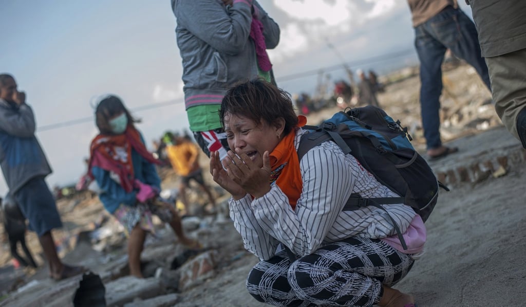 Residents of a village heavily damaged by the tsunami in Palu, Central Sulawesi, Indonesia. Photo: AP