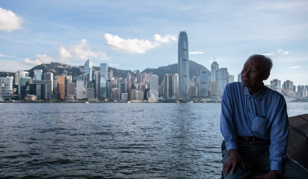 An elderly man looks out to Victoria Harbour. Photo: AFP Photo