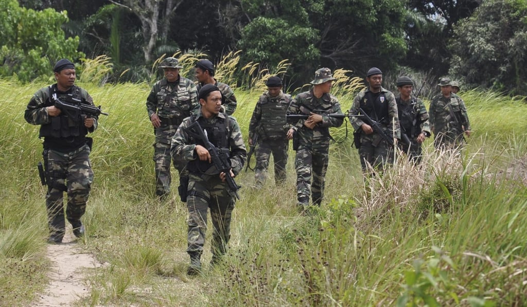 Malaysian soldiers during an operation at Kampung Tanduo near Lahad Datu. Photo: EPA