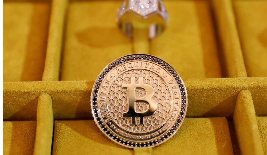 Jewellery with the bitcoin logo is seen on display at the Consensus 2018 blockchain technology conference in New York. Photo: Reuters