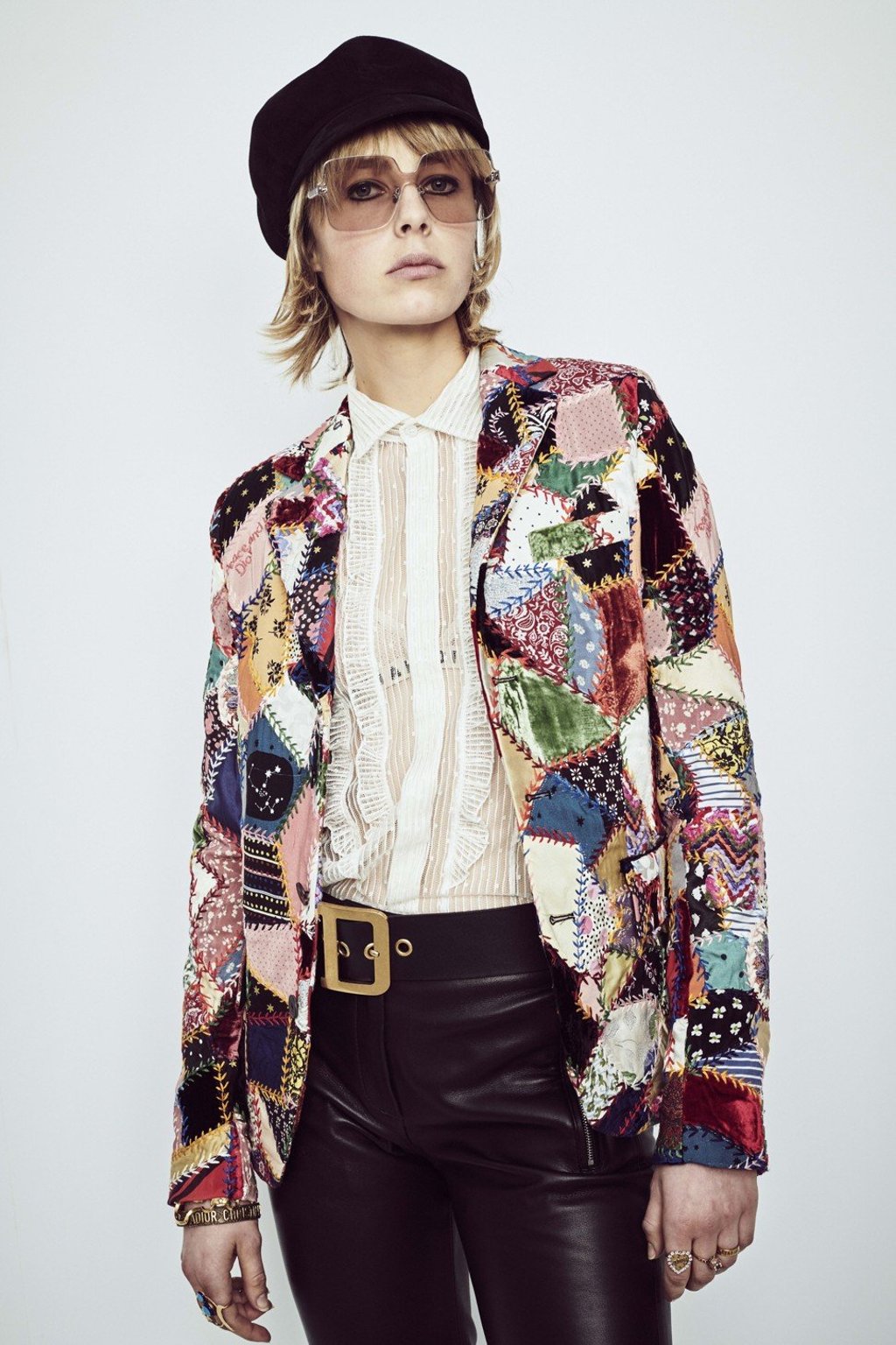 A patchwork jacket is matched with shiny skin-tight trousers for a street style mixed with high fashion look. A patchwork jacket is matched with shiny skin-tight trousers for a street style mixed with high fashion look.