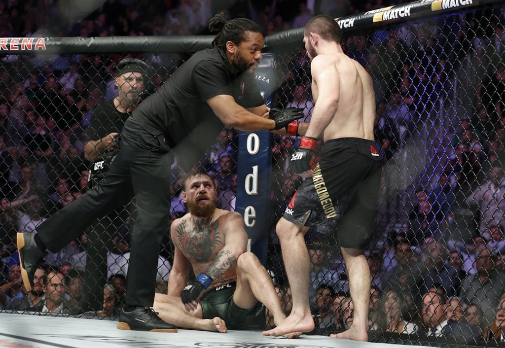 Khabib Nurmagomedov (right) is held back by referee Herb Dean after submitting Conor McGregor. Photo: AP Khabib Nurmagomedov (right) is held back by referee Herb Dean after submitting Conor McGregor. Photo: AP