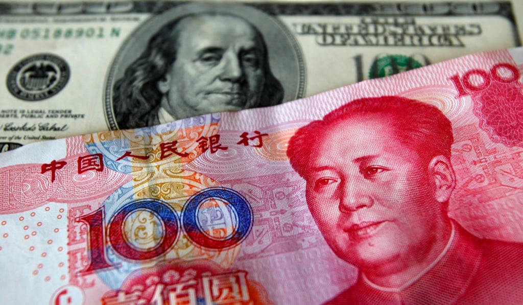 A yuan banknote displayed next to a US dollar. Photo: Reuters