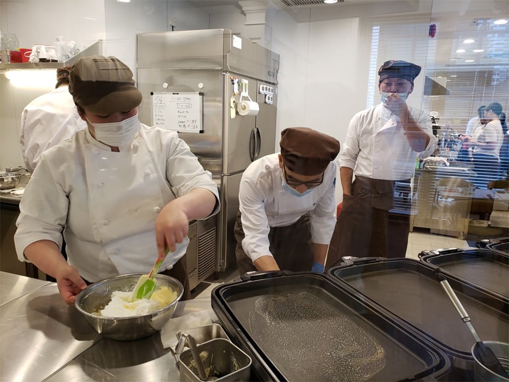 Chefs at A Happy Pancake in Causeway Bay hard at work in the kitchen behind a large glass partition. Photo: Aydee Tie Chefs at A Happy Pancake in Causeway Bay hard at work in the kitchen behind a large glass partition. Photo: Aydee Tie