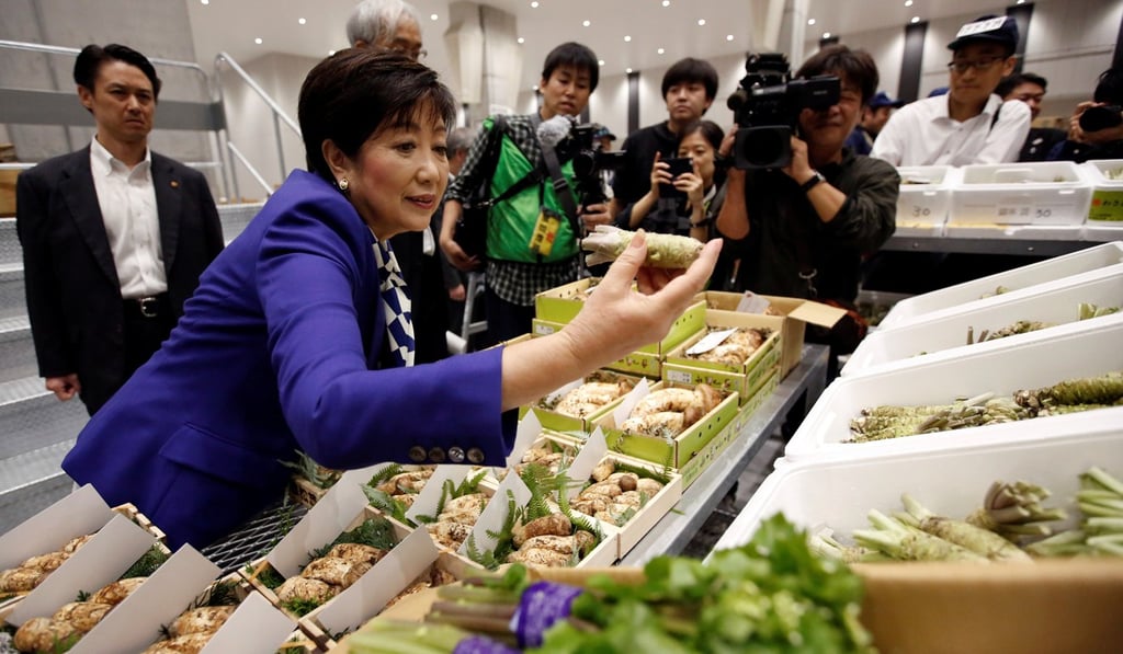 Tokyo Governor Yuriko Koike inspects a greengrocery area on the opening day of the new Toyosu market. Photo: Reuters