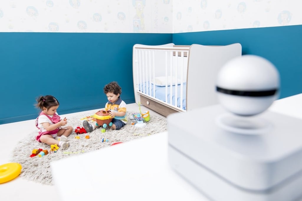 A Moon smart home hub, with a floating 360-degree camera, levitating by means of magnets.