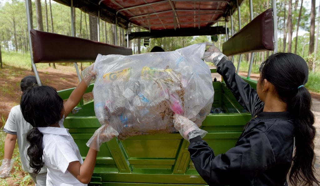 Students of Coconut School collecting discarded plastic water bottles and other recyclable scraps at Kirirom National Park. Photo: AFP Students of Coconut School collecting discarded plastic water bottles and other recyclable scraps at Kirirom National Park. Photo: AFP