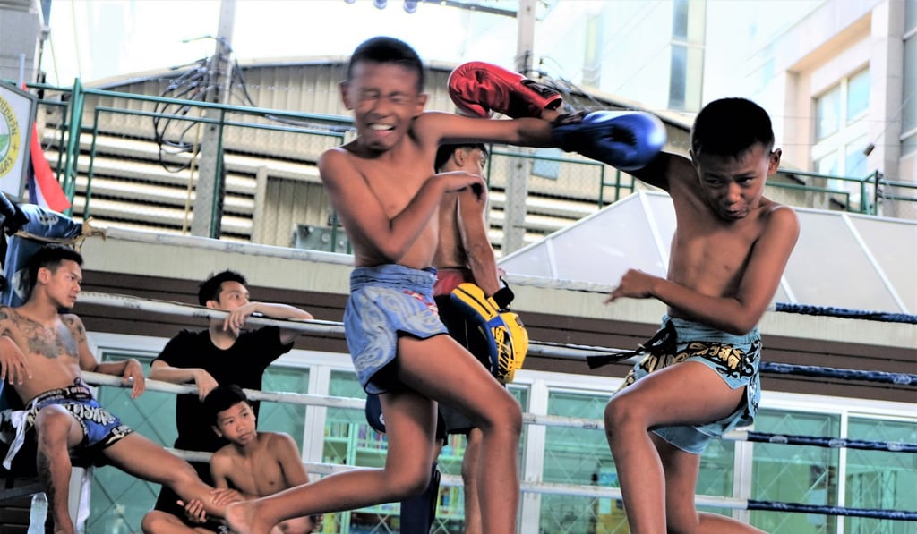 Jirasak punches his twin brother, Pornsak, during one of the sparring sessions at a Bangkok boxing camp. Photo: Tibor Krausz