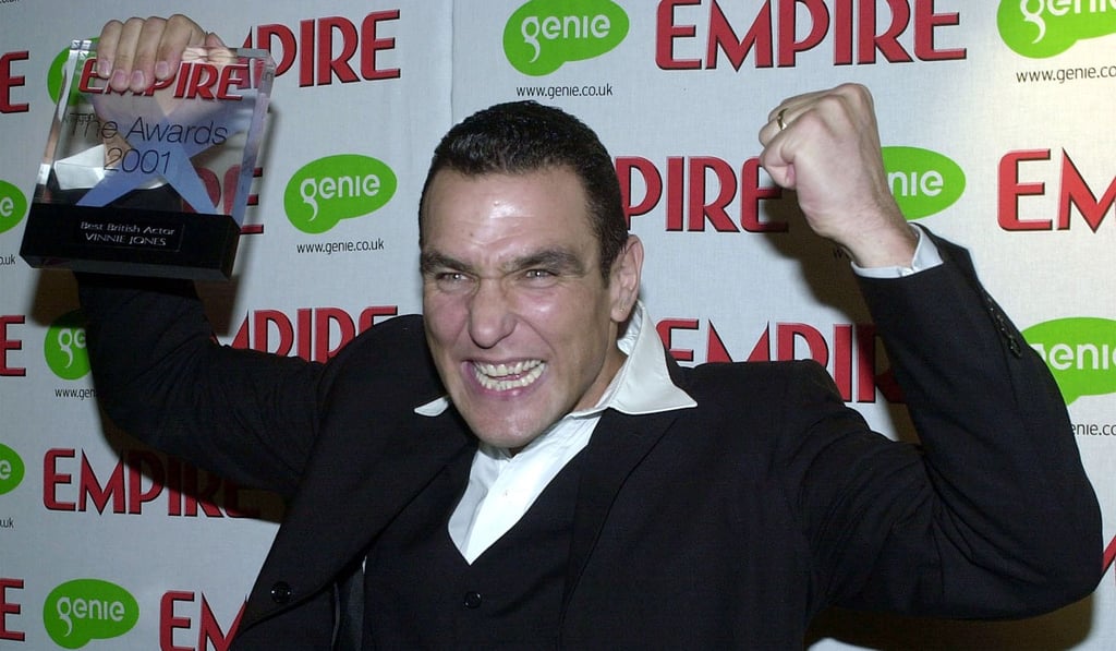 Vinnie Jones celebrating after he was awarded the 2001 Empire Film Award for best actor at a gala evening in London. Photo: AP
