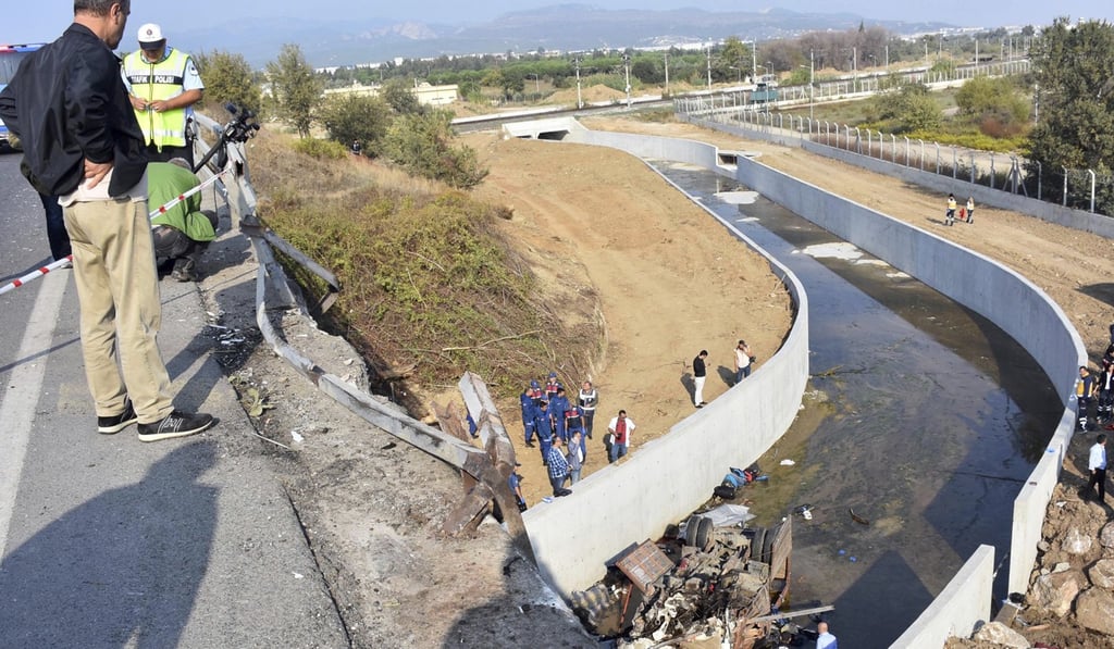 Rescue workers inspect the scene of the accident that killed over a dozen migrants and injured numerous more in Izmir, Turkey. Photo: AP Rescue workers inspect the scene of the accident that killed over a dozen migrants and injured numerous more in Izmir, Turkey. Photo: AP