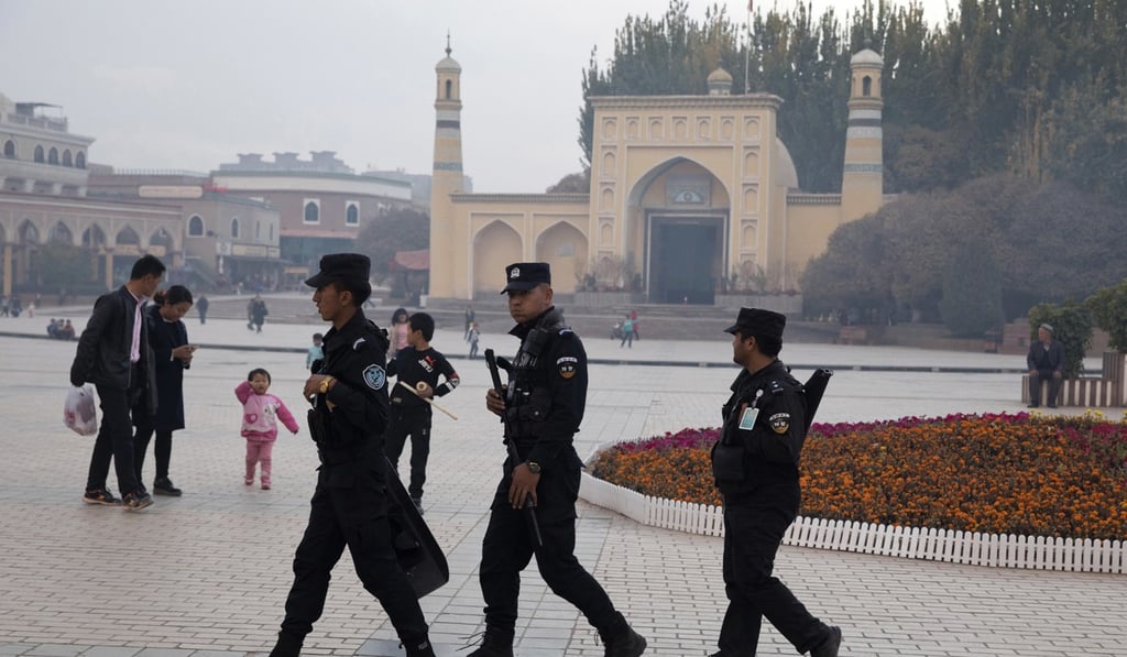 Uygur security personnel patrol near the Id Kah Mosque in Kashgar in western China's Xinjiang region. China's northwestern region of Xinjiang has revised legislation to allow the detention of suspected extremists in “education and training centers”. Photo: AP Uygur security personnel patrol near the Id Kah Mosque in Kashgar in western China's Xinjiang region. China's northwestern region of Xinjiang has revised legislation to allow the detention of suspected extremists in “education and training centers”. Photo: AP