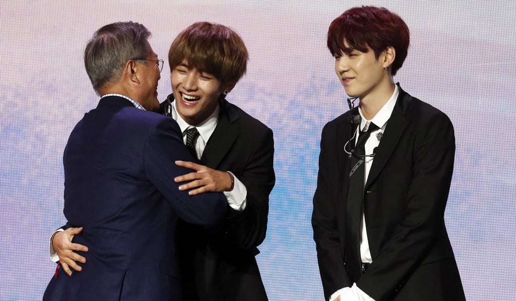 Moon with members of the South Korean pop group BTS who performed in Paris on Sunday. Photo: AP Moon with members of the South Korean pop group BTS who performed in Paris on Sunday. Photo: AP