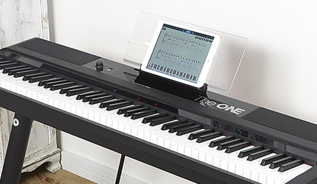 The ONE Smart Keyboard Pro, which connects to a tablet to provide interactive lessons and video games as an alternative to private lessons. The ONE Smart Keyboard Pro, which connects to a tablet to provide interactive lessons and video games as an alternative to private lessons.