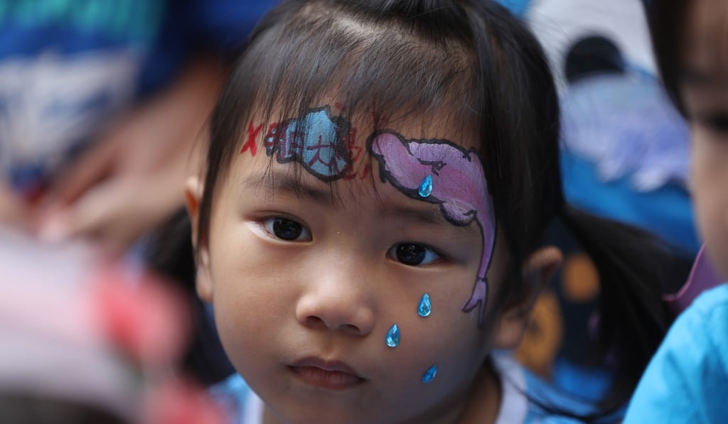 A young protester’s concern for the environment is written all over her face. Photo: Edward Wong