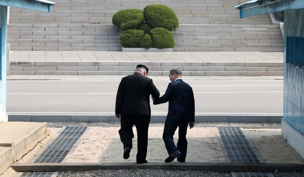 South Korean President Moon Jae-in and North Korean leader Kim Jong-un hold hands as they cross the military demarcation line at the Joint Security Area in the demilitarised zone. Photo: EPA South Korean President Moon Jae-in and North Korean leader Kim Jong-un hold hands as they cross the military demarcation line at the Joint Security Area in the demilitarised zone. Photo: EPA