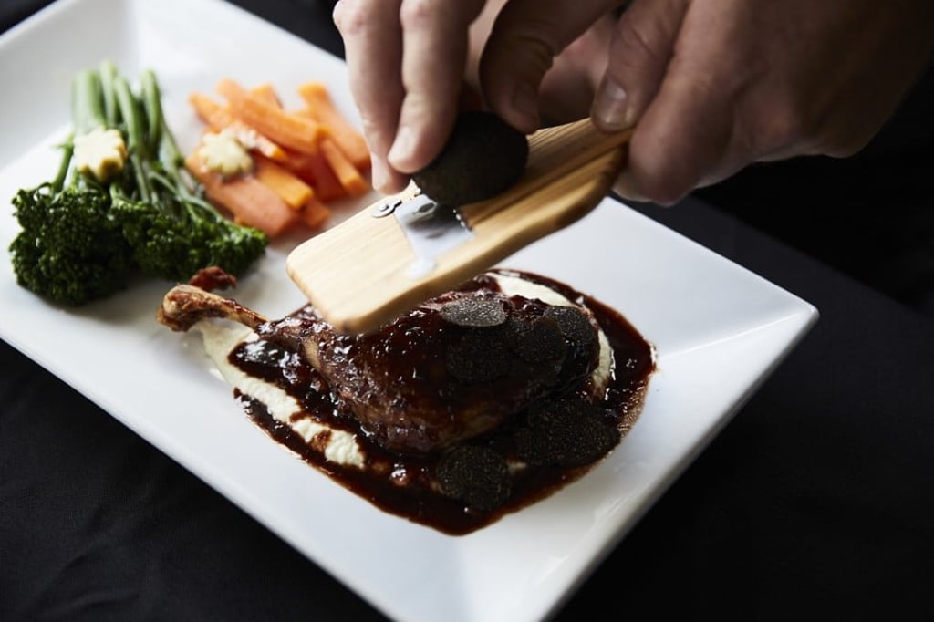 A chef shaving a black truffle from The Truffle & Wine Co. Expert chefs say Australian black truffles taste as good as French black truffles.