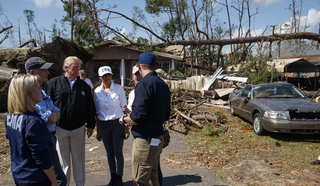 FEMA director Brock Long, right, talks with from left, Homeland Security Secretary Kirstjen Nielsen, Florida Governor Rick Scott, President Donald Trump, first lady Melania Trump and Margo Anderson, Mayor of Lynn Haven, Florida, second from right, as they tour a neighbourhood affected by Hurricane Michael on Monday in Lynn Haven. Photo: AP