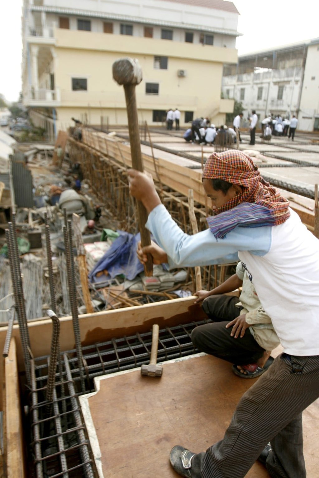 Construction workers build a new apartment complex in Phnom Penh. Photo: AP
