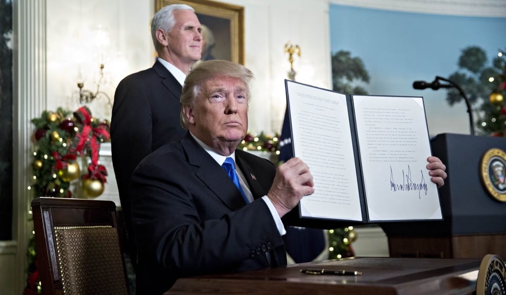 US President Donald Trump holds up a proclamation after declaring Jerusalem to be Israel’s capital. Photo: Bloomberg