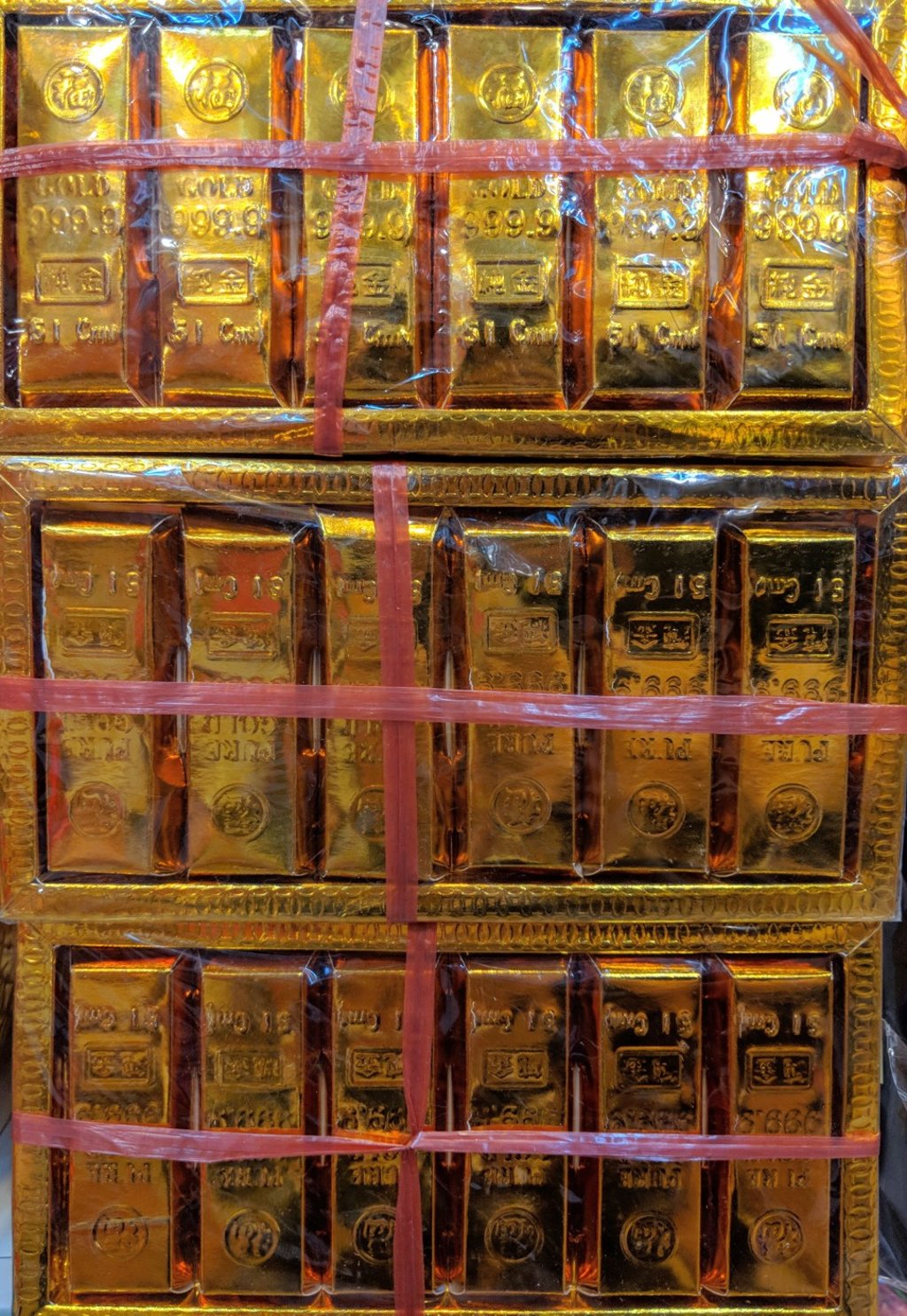 Boxes of paper gold bars on sale in a shop, which will be burned as an offering to ancestors to ensure they will always remain wealthy – even after death. Photo: Lisa Cam