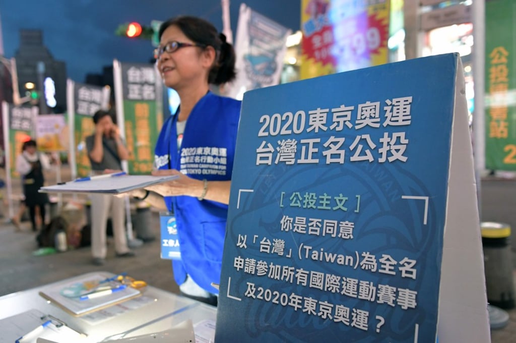 A woman collects signatures for a referendum on the streets in Taipei. Photo: AFP A woman collects signatures for a referendum on the streets in Taipei. Photo: AFP
