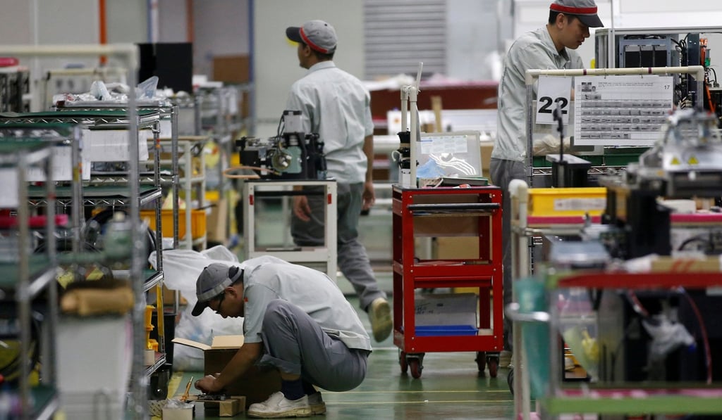 Employees are seen by their workstations at a printed circuit board assembly factory in this file photo. Singapore has been ranked the world’s second-most competitive economy by the World Economic Forum. Photo: Reuters