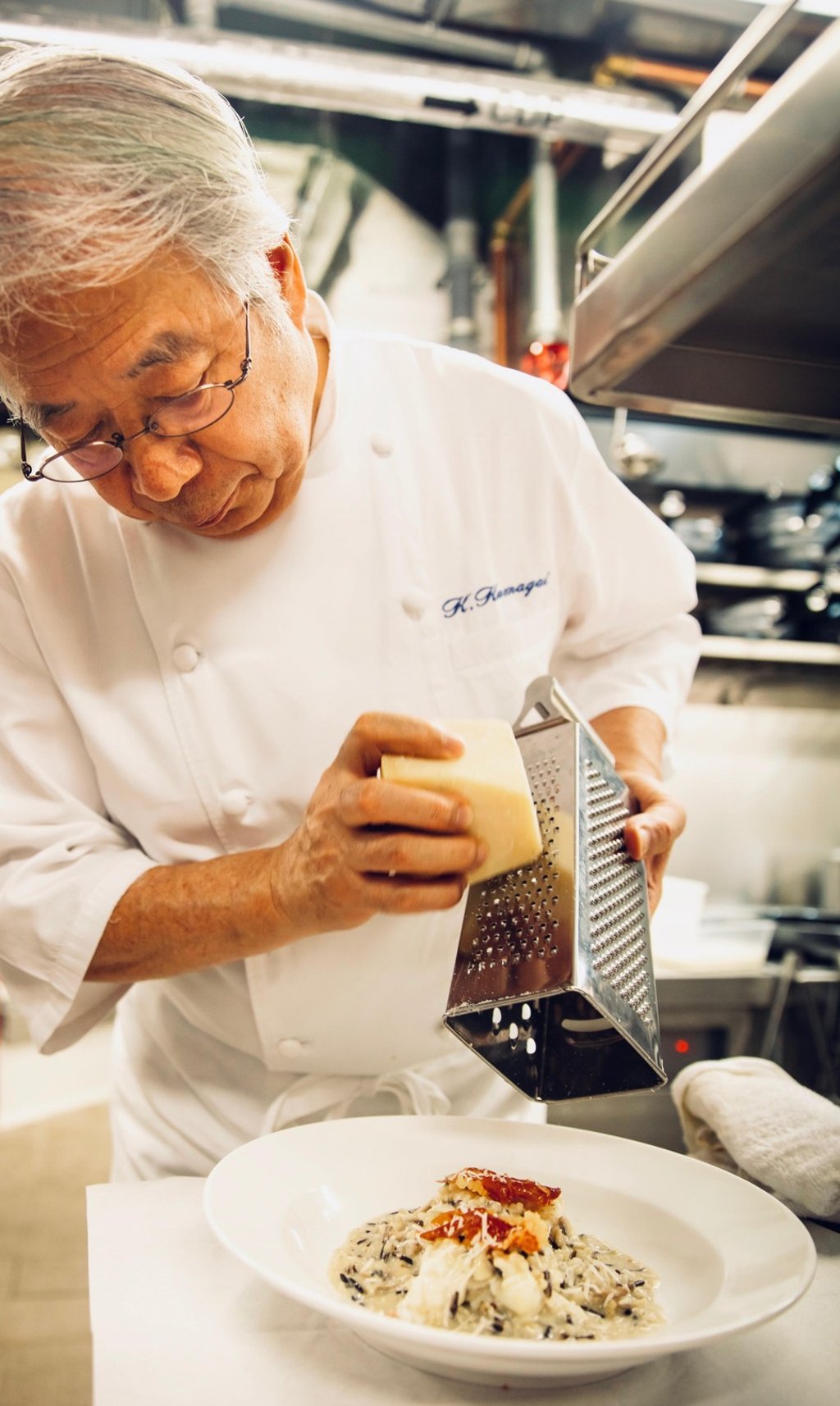 Chef Kihachi Kumagai adds the finishing touches to a dish in the kitchens at Lumi.