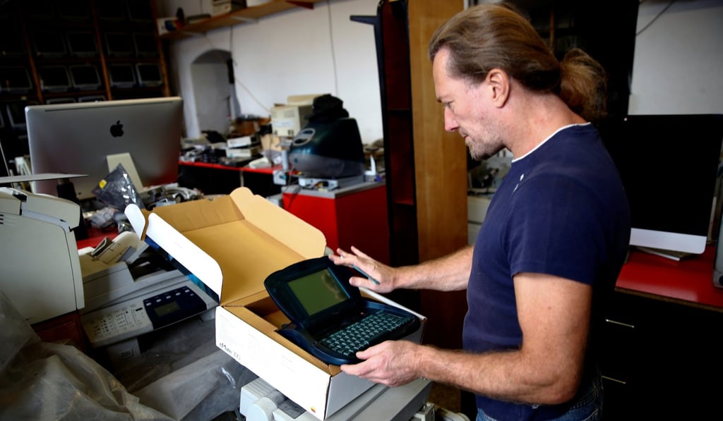Austrian Apple computer collector Roland Borsky with an eMate 300. Photo: Reuters