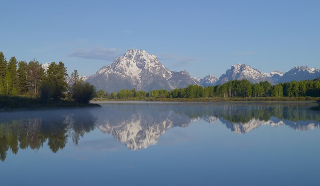 A mirror-smooth lake in Grand Teton National Park, Wyoming. A mirror-smooth lake in Grand Teton National Park, Wyoming.
