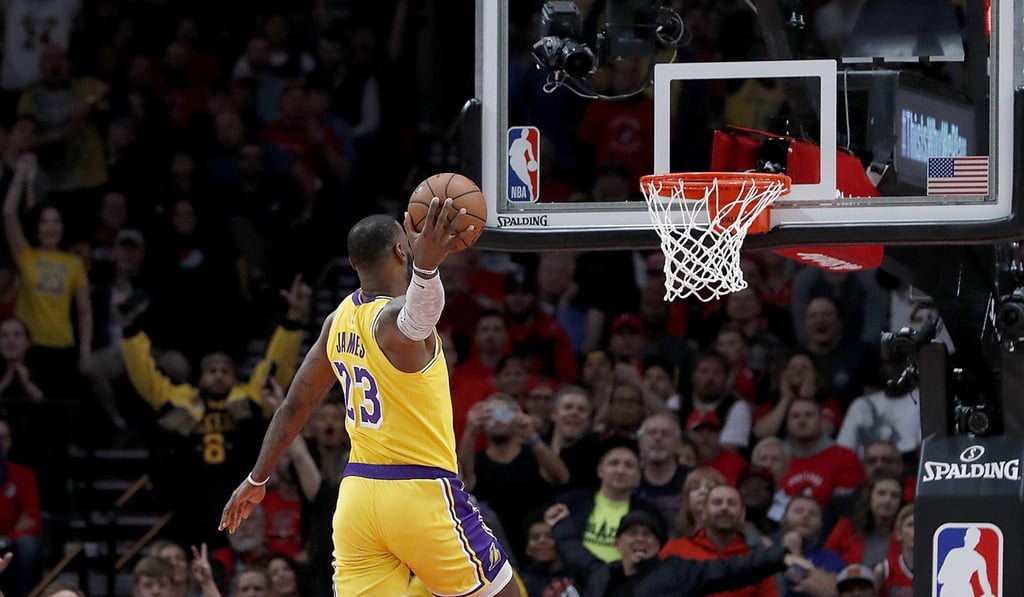 The Los Angeles Lakers’ LeBron James slams one in early on in his first game for his new team against the Portland Trail Blazers. Photo: TNS
