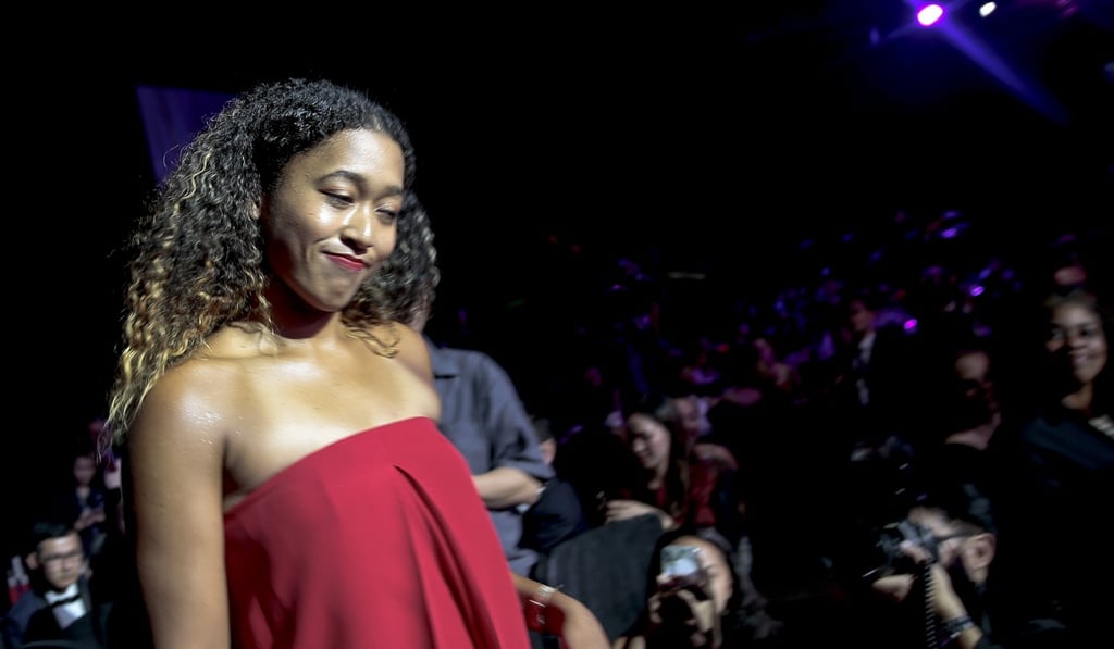 Naomi Osaka enters the ballroom for the singles draw ceremony at the Marina Bay Sands Hotel in Singapore. Photo: EPA