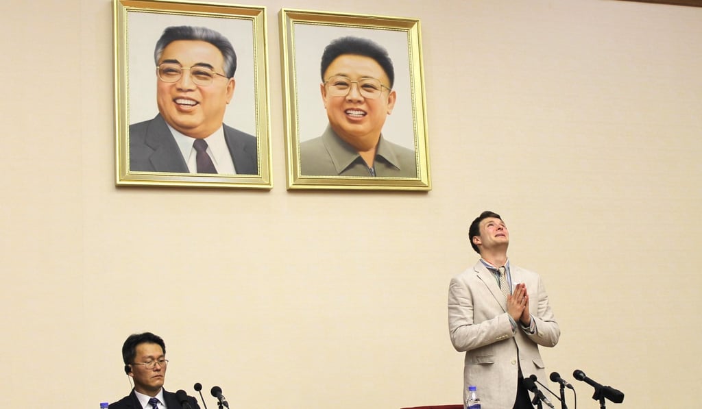 Warmbier pleads during a press conference in Pyongyang beneath portraits of the late Kim Il-sung and Kim Jong-il. Picture: Alamy