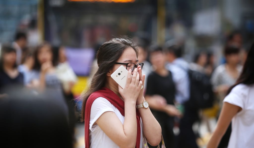 A woman covers her nose in Causeway Bay. Euro VI vehicles emit about 90 per cent less nitrogen dioxide than Euro IV vehicles. Photo: Sam Tsang