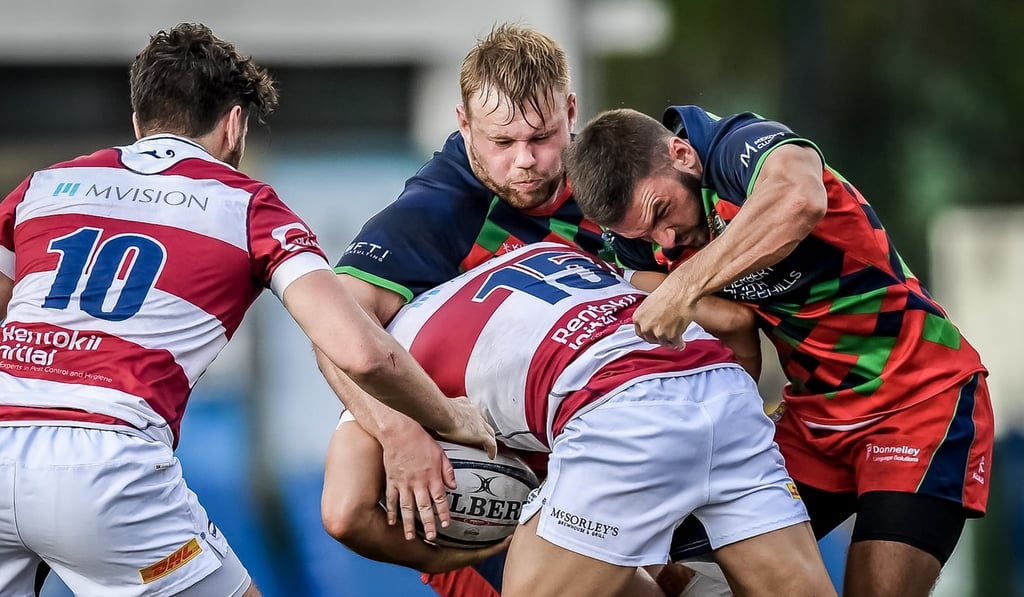 Rory Cinnamond (centre in blue) playing for Sandy Bay.