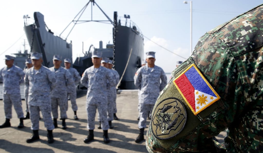 Philippine Navy troops stand at attention during a ceremony on Wednesday before boarding a landing ship to take part in the first China-Asean maritime drill. Photo: AP